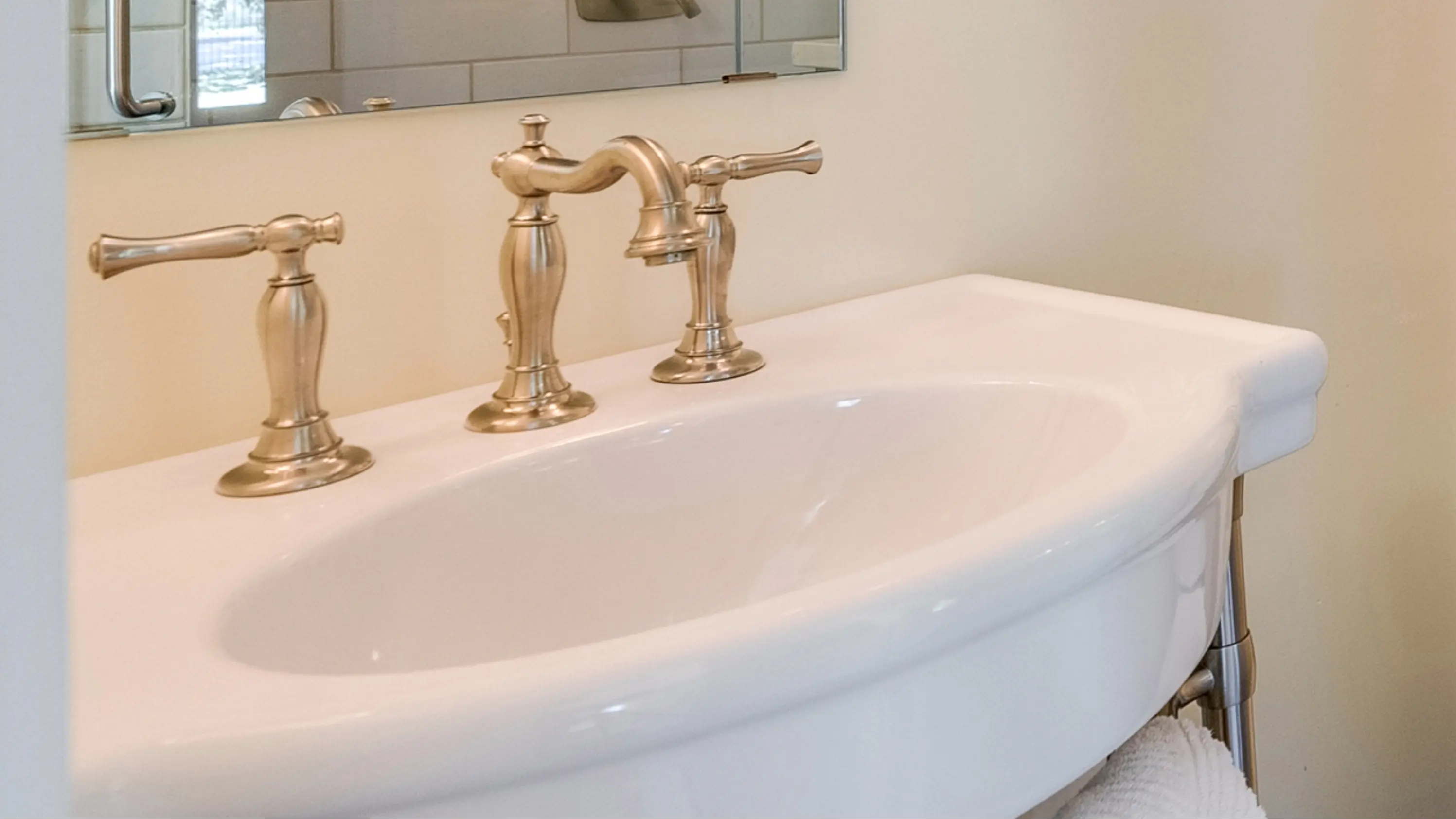 Gold faucet on a white sink
