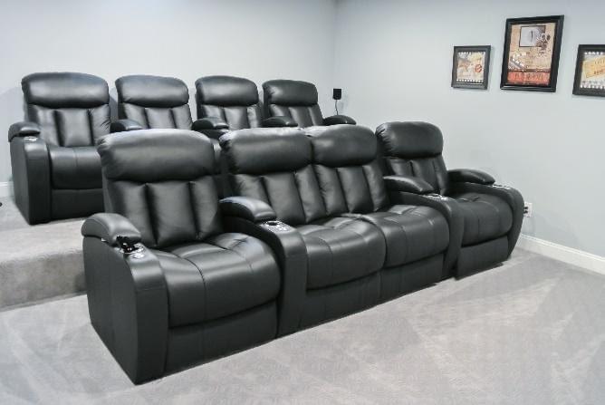 Black recliners in a movie-theater setup